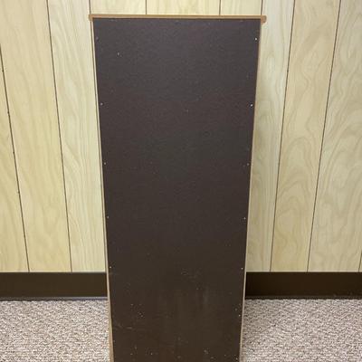 Sale Photo Thumbnail #402: White wooden cabinet featuring an open upper shelf compartment and a lower section enclosed by a paneled door with a round knob. The cabinet measures 10 inches deep, 12.5 inches wide, and 29.5 inches tall. It includes two shelves behind the door. The over