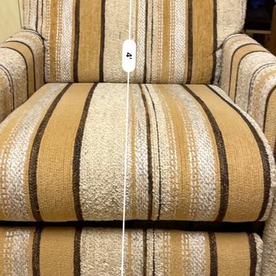 Sale Photo Thumbnail #431: Adjustable recliner featuring a sturdy wooden frame and textured striped fabric upholstery in earth-toned hues. Includes a reclining mechanism for enhanced comfort. Dimensions: 3'7" wide, 27" seat depth, and 42" overall height. The chair is in good condit