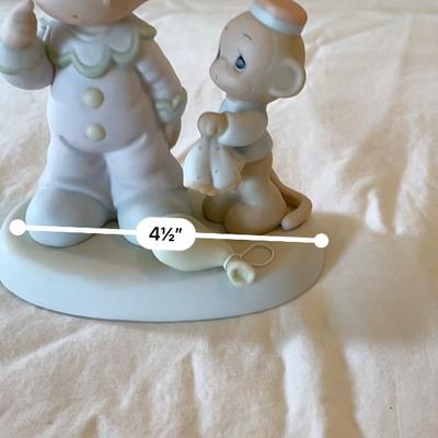 Sale Photo Thumbnail #538: Precious Moments porcelain bisque figurine by Enesco featuring a child in pastel outfit and hat, standing with a toy duck on a pull string. Produced exclusively for Precious Moments and dated 1994, marked on the base. Measures approximately 5.5 inches tal