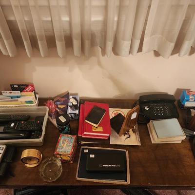 Sale Photo Thumbnail #354: Lot of misc items including Post-it-Notes, remotes, cameras, pens, coin grading books, bookends, backpack (container not included)