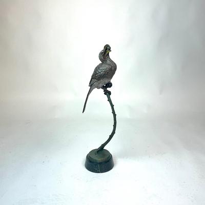 Sale Photo Thumbnail #93: Made out of bronze and polychrome.Hornbill depicted with an egg in its beak, its talons gripping a curved branch; on black round stepped plinth base.  
Measurements:
Bird is 14.5" height, 6.5" diameter for base, total height is 28" height
Valued @ $2500.0