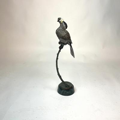 Sale Photo Thumbnail #94: Made out of bronze and polychrome.Hornbill depicted with an egg in its beak, its talons gripping a curved branch; on black round stepped plinth base.  
Measurements:
Bird is 14.5" height, 6.5" diameter for base, total height is 28" height
Valued @ $2500.0