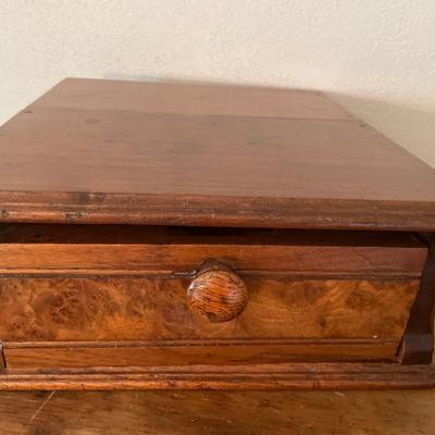 Wood box with composition notebooks and paper weight