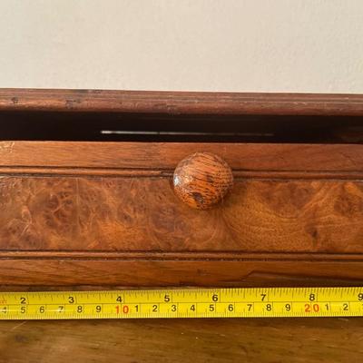 Wood box with composition notebooks and paper weight