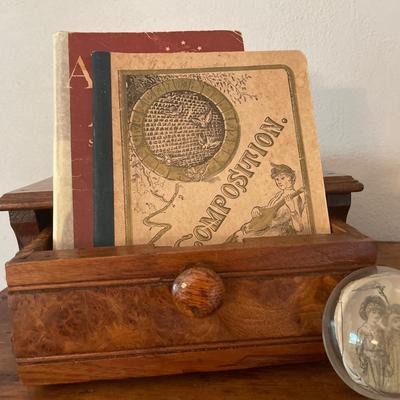 Wood box with composition notebooks and paper weight
