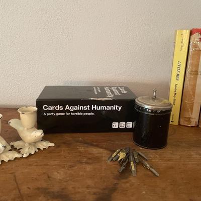 Books, game, bird candleholders and quills