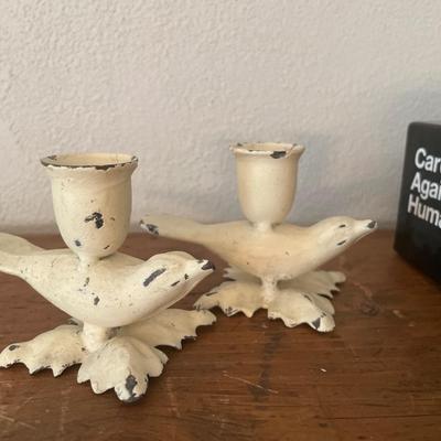 Books, game, bird candleholders and quills