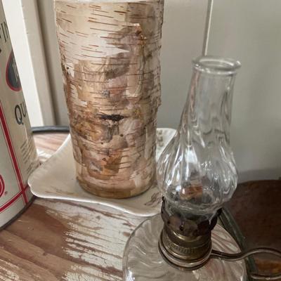 Campfire and oil lamps with thermos and candle