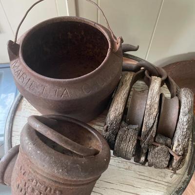 Vintage pulley and cast iron well and cauldron