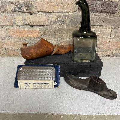 Sale Photo Thumbnail #247: Articulated wooden shoe mold, cast iron she mold, square glass jug, and very unique Rolls razor in the box