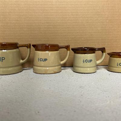 Sale Photo Thumbnail #264: Set of 4 measuring pitchers, lug, lidded pot, trio of condiment pots, two mustard pot duos, and set of salt & pepper shakers