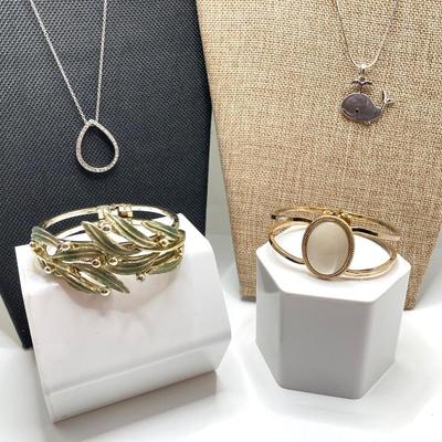 LOT 256: Teardrop and Whale Pendant Necklaces with Pair of Hinged Cuff Bracelets