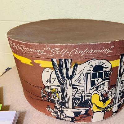 LOT 277: Cowboy Collection Featuring a Vintage Resistol Hat Box, Two (2) Cowboy Hats, Horseshoes and Books