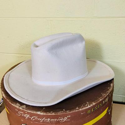 LOT 277: Cowboy Collection Featuring a Vintage Resistol Hat Box, Two (2) Cowboy Hats, Horseshoes and Books