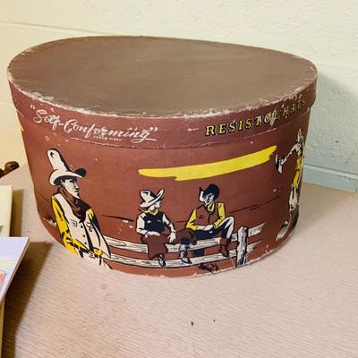 LOT 277: Cowboy Collection Featuring a Vintage Resistol Hat Box, Two (2) Cowboy Hats, Horseshoes and Books