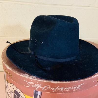 LOT 277: Cowboy Collection Featuring a Vintage Resistol Hat Box, Two (2) Cowboy Hats, Horseshoes and Books