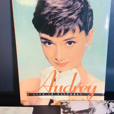 LOT 360: Collection Inspired by Remarkable Women Including Judy Garland Book and Stamps, Audrey Hepburn Books, and More