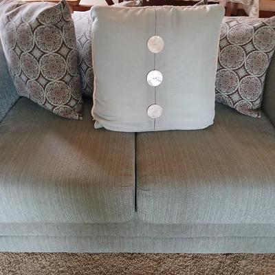 Teal Upholstered Loveseat with Accent Pillows