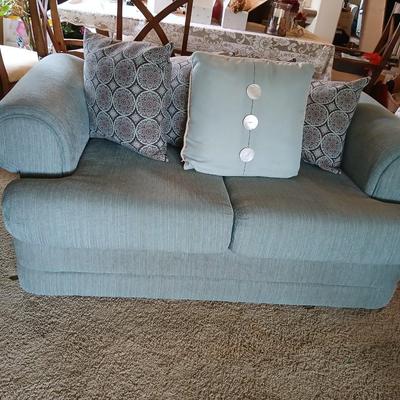 Teal Upholstered Loveseat with Accent Pillows