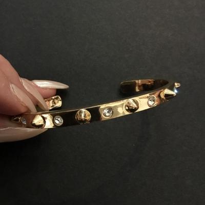 Very nice gold toned, rhinestone spike cuff bracelet