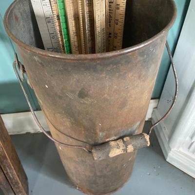 Yard sticks in vintage canister