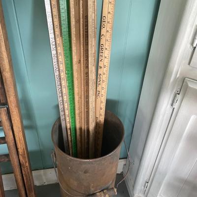 Yard sticks in vintage canister
