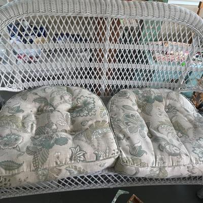 White wicker loveseat with cushions