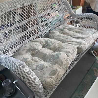 White wicker loveseat with cushions