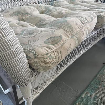 White wicker loveseat with cushions