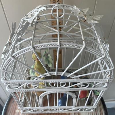 Metal bird cage with ceramic bird figurines