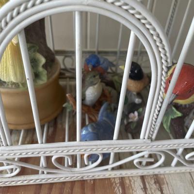 Metal bird cage with ceramic bird figurines