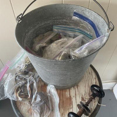 Bucket of vintage handles and hooks