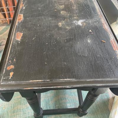 Black painted table with drop leaf sides and purple tea set