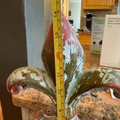 Sale Photo Thumbnail #63: Add a touch of French charm to your home or garden with this distressed fleur-de-lis finial. Heavy cast resin with worn red and sage green finish gives it a rustic, vintage look.

Details:

Approx. 10–12" tall

Beautiful ornate base

Great as a shelf ac