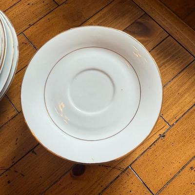 Sale Photo Thumbnail #103: Timeless and refined, this 1995 “Classic Elegance” fine china set by The Cellar includes dinner plates, salad plates, bowls, cups, a teapot, creamer, sugar bowl, and serving pieces. White with a thin gold rim, perfect for formal dining or holiday gath