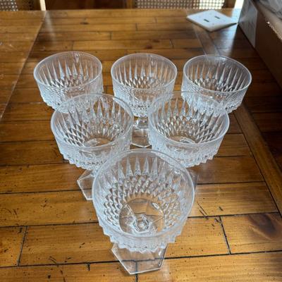 Sale Photo Thumbnail #121: Classic footed sherbet glasses with faceted stems and cut glass detailing. Ideal for serving desserts or fruit compote.