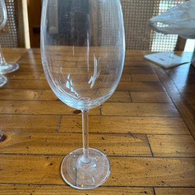Sale Photo Thumbnail #136: Beautiful clear wine glasses with etched floral detailing. Tall stems and wide bowls make them ideal for red or white wine.
