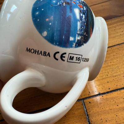 Sale Photo Thumbnail #145: Charming souvenir-style ceramic mug with a winter village scene and interior volume marking. Likely from a European Christmas market (0.2L marking)