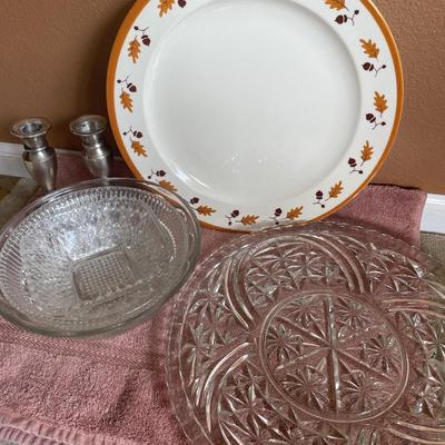 Clear glass serving dishes and silver tone candle stick holders