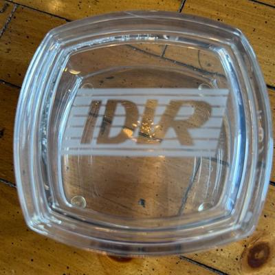 Sale Photo Thumbnail #163: Square glass ashtray etched with “IDLR” logo—heavy-duty and clean design. Great as a collector’s piece or industrial-style catchall.