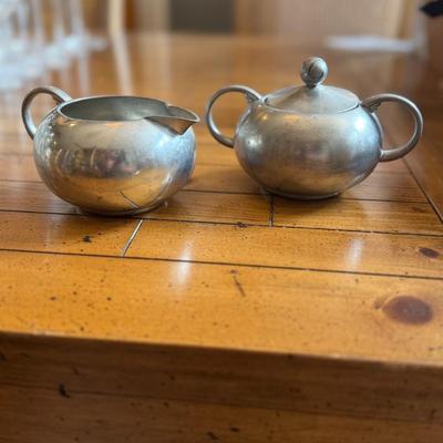 Sale Photo Thumbnail #165: A charming, matte pewter creamer and lidded sugar bowl set with simple, rounded form. Lovely patina for vintage display or tea service.