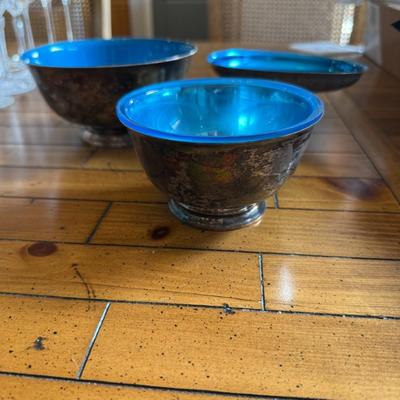 Sale Photo Thumbnail #167: Striking set of three mid-century silver-toned footed bowls with vibrant blue glass interiors. Unique accent bowls or serving pieces.