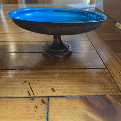 Sale Photo Thumbnail #168: Striking set of three mid-century silver-toned footed bowls with vibrant blue glass interiors. Unique accent bowls or serving pieces.