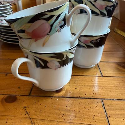 Sale Photo Thumbnail #175: Elegant porcelain dinnerware with black border and soft pink tulip pattern. Service for 4–6 includes plates, bowls, mugs, and serving pieces. Marked "Westbrook Collections - Mirage - Japan".