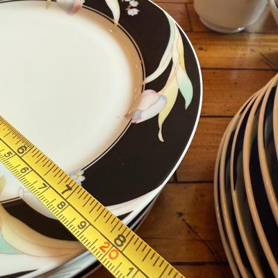 Sale Photo Thumbnail #181: Elegant porcelain dinnerware with black border and soft pink tulip pattern. Service for 4–6 includes plates, bowls, mugs, and serving pieces. Marked "Westbrook Collections - Mirage - Japan".