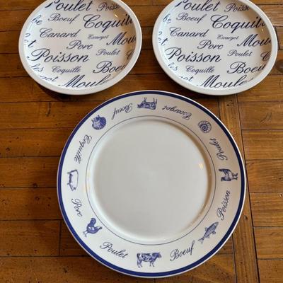 Sale Photo Thumbnail #192: Classic white and blue ceramic plates with French words and illustrations for meats and seafood (Poulet, Boeuf, Poisson, etc.). Bistro-style charm for kitchen or display.