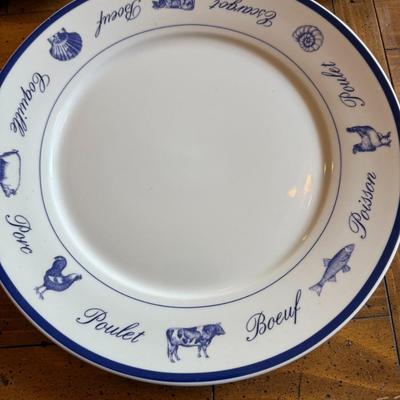 Sale Photo Thumbnail #193: Classic white and blue ceramic plates with French words and illustrations for meats and seafood (Poulet, Boeuf, Poisson, etc.). Bistro-style charm for kitchen or display.