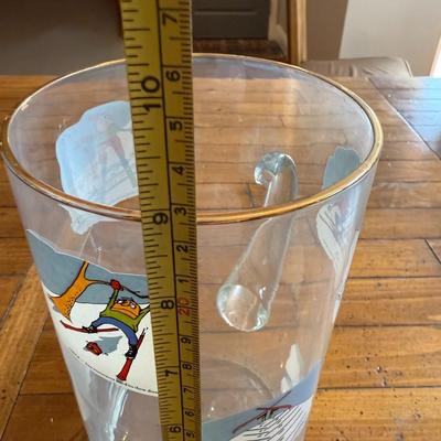 Sale Photo Thumbnail #202: Clear glass mug featuring whimsical vintage ski illustrations. Fun collector’s piece.