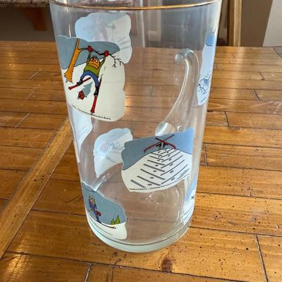 Sale Photo Thumbnail #201: Clear glass mug featuring whimsical vintage ski illustrations. Fun collector’s piece.