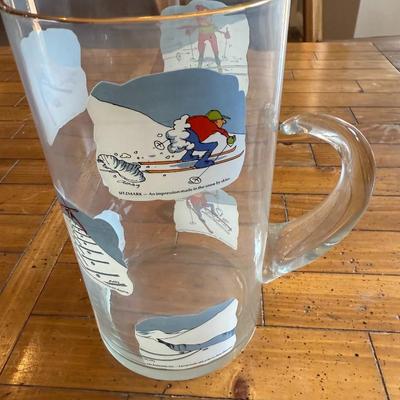Sale Photo Thumbnail #203: Clear glass mug featuring whimsical vintage ski illustrations. Fun collector’s piece.